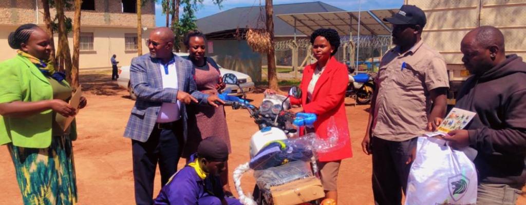 CAO (Extreme Left) and RDC (Second Left) receiving a motorcycle from the Ministry for the GROW loan project. GROW program motorcycle handed over to the District Executive